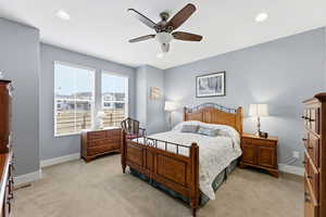 Bedroom featuring a ceiling fan, light colored carpet, and recessed lighting