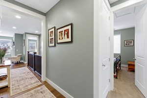 Hall with plenty of natural light, recessed lighting, and light wood-type flooring