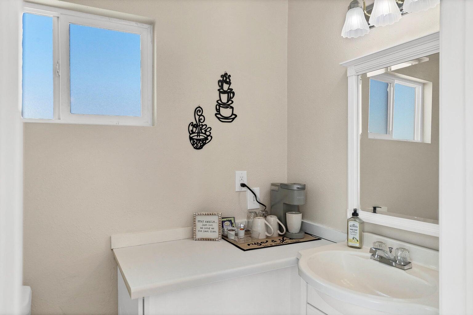White vanity with a built-in sink and chrome faucet