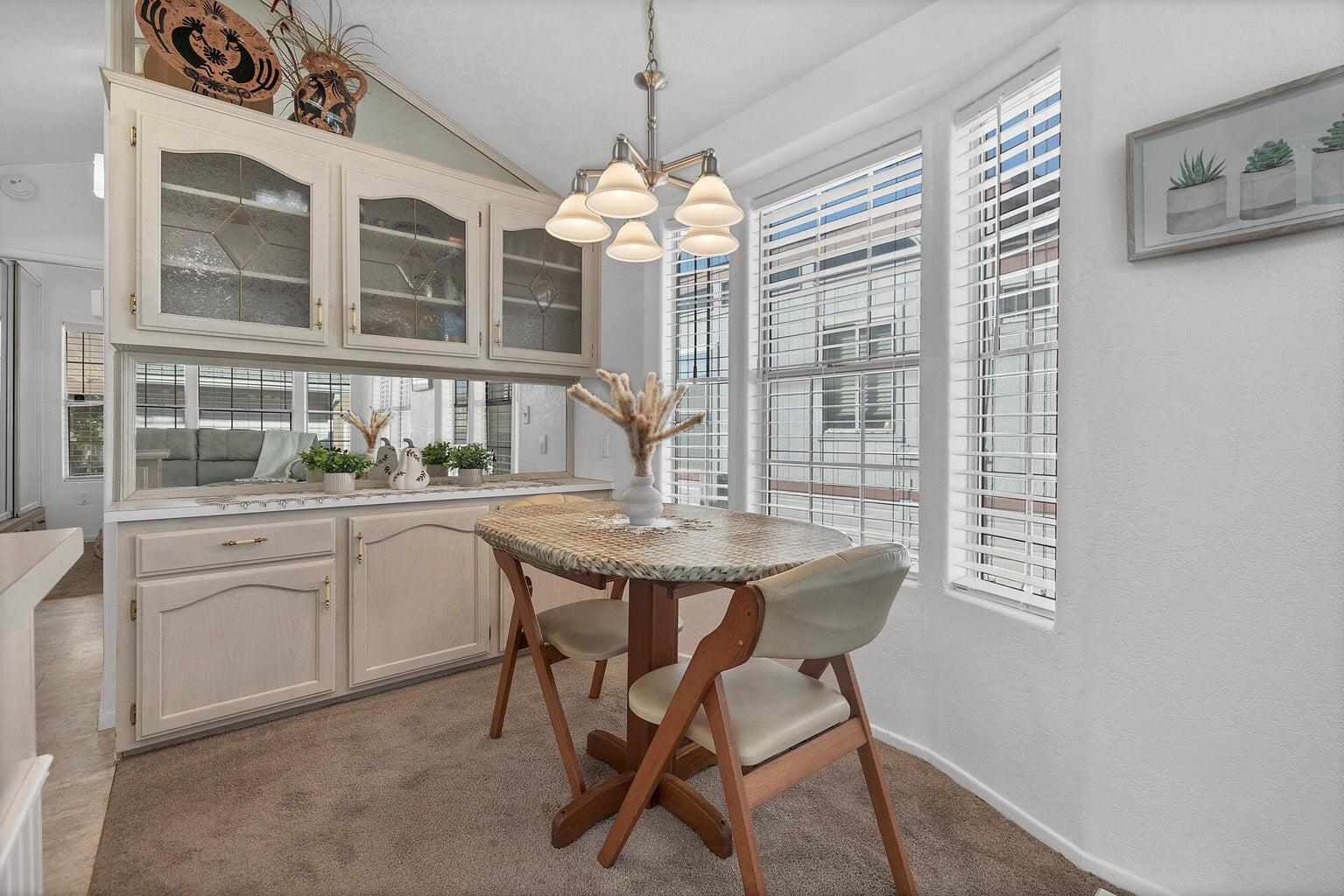 Integrated cabinetry with glass-front uppers and lower storage, complemented by a mirrored backsplash