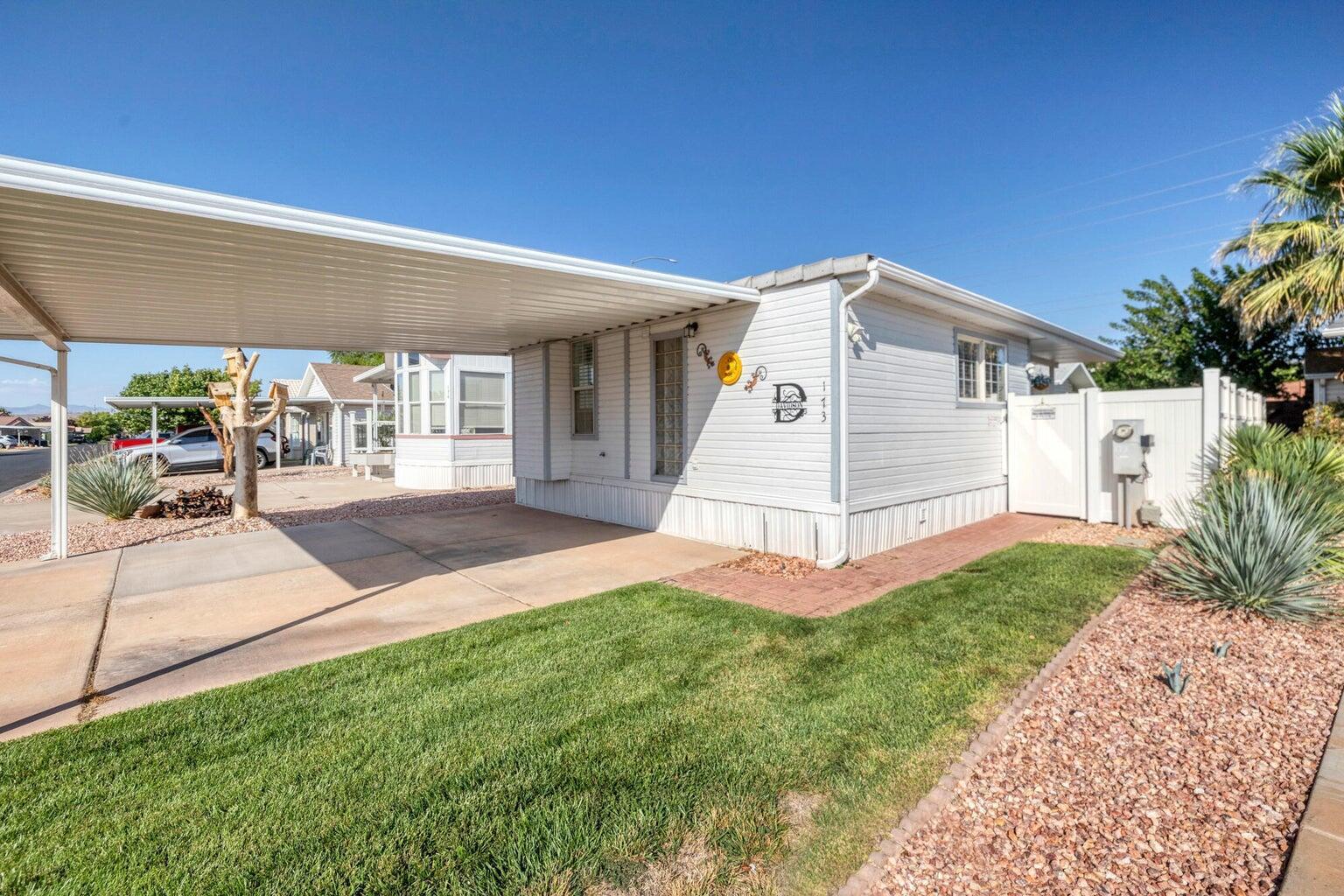 White vinyl siding exterior with a covered carport