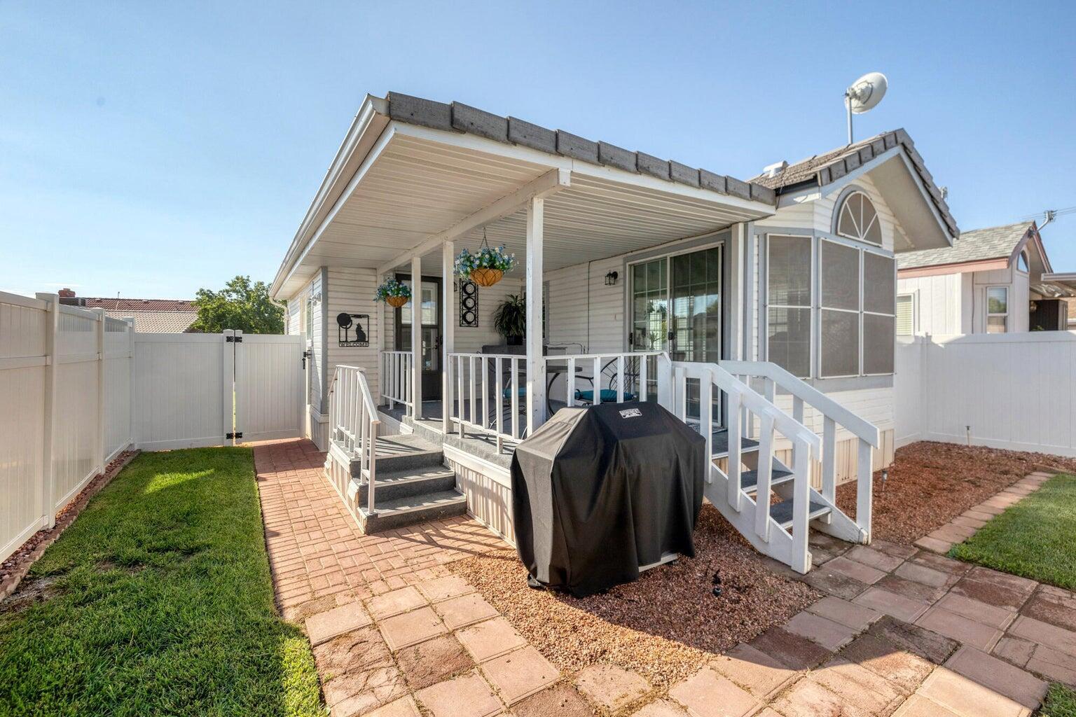 Exterior featuring a covered porch, white railing, and steps