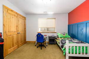 Bedroom featuring carpet flooring and a closet
