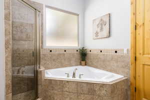 Full bathroom with a stall shower and a garden tub