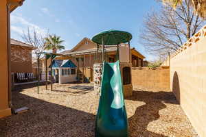 View of play area featuring a fenced backyard