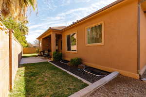 Fenced backyard with a patio area and a ceiling fan