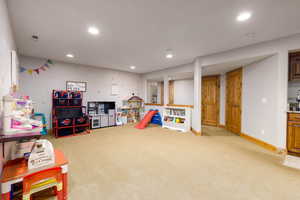 Rec room with light colored carpet and recessed lighting
