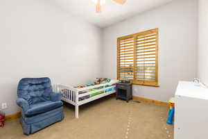 Bedroom with light carpet and ceiling fan