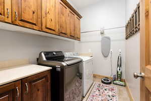 Laundry room featuring cabinet space and separate washer and dryer