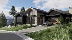 View of front of home with stone siding, a garage, driveway, and a chimney