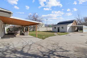 View of patio featuring an outdoor structure and an outdoor hangout area