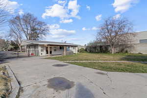 View of front of property featuring a gate, driveway, and a porch