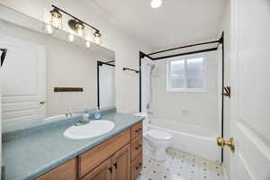 Bathroom featuring vanity, shower / bath combination, and light floors