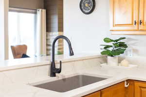 Kitchen view of light stone countertops and a sink