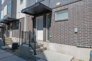 Entrance to property with brick siding