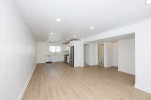 Unfurnished living room featuring recessed lighting and light wood-style flooring