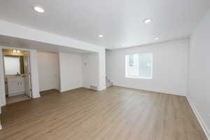 Spare room with light wood finished floors and recessed lighting