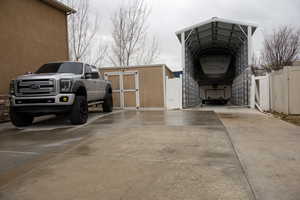 Exterior space with driveway and a detached carport