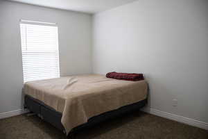 Carpeted bedroom featuring baseboards