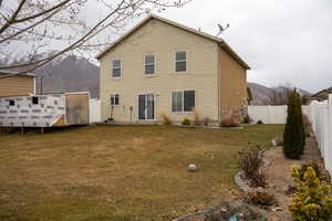 Rear view of property featuring a fenced backyard