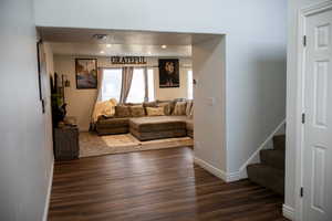 Living room featuring dark wood-style flooring and recessed lighting