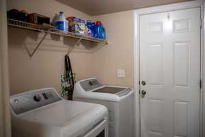 Laundry room with a textured ceiling and washer and dryer