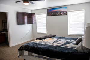 Bedroom featuring carpet, ceiling fan, and a textured ceiling