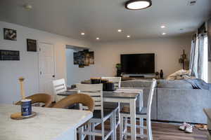Dining space featuring wood finished floors and recessed lighting