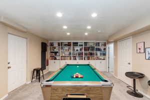 Recreation room with light carpet, billiards table, and recessed lighting
