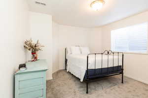 Carpeted bedroom featuring baseboards