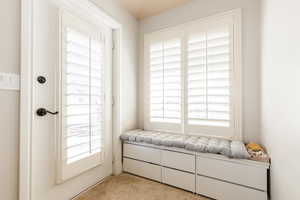 Sitting room featuring light colored carpet
