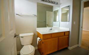 Bathroom featuring vanity and dark tile patterned floors