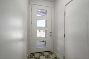 Contemporary entry door with four rectangular lites and brushed nickel hardware