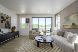 Expansive living area with wood-finish flooring, recessed lighting, and a large sliding glass door