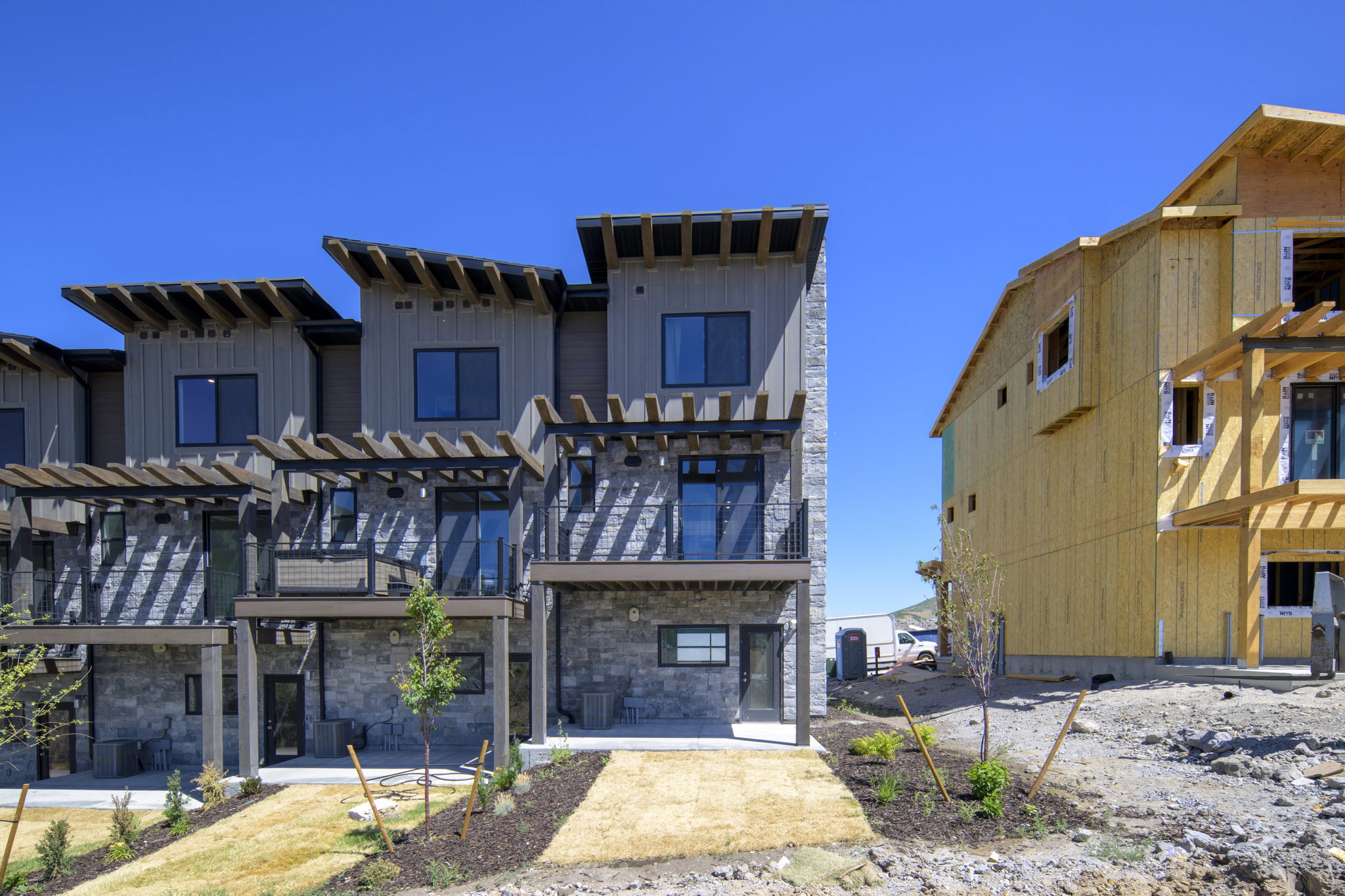 Contemporary townhome row featuring multi-level design