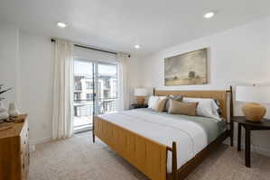 Bedroom with light colored carpet, access to exterior, and recessed lighting