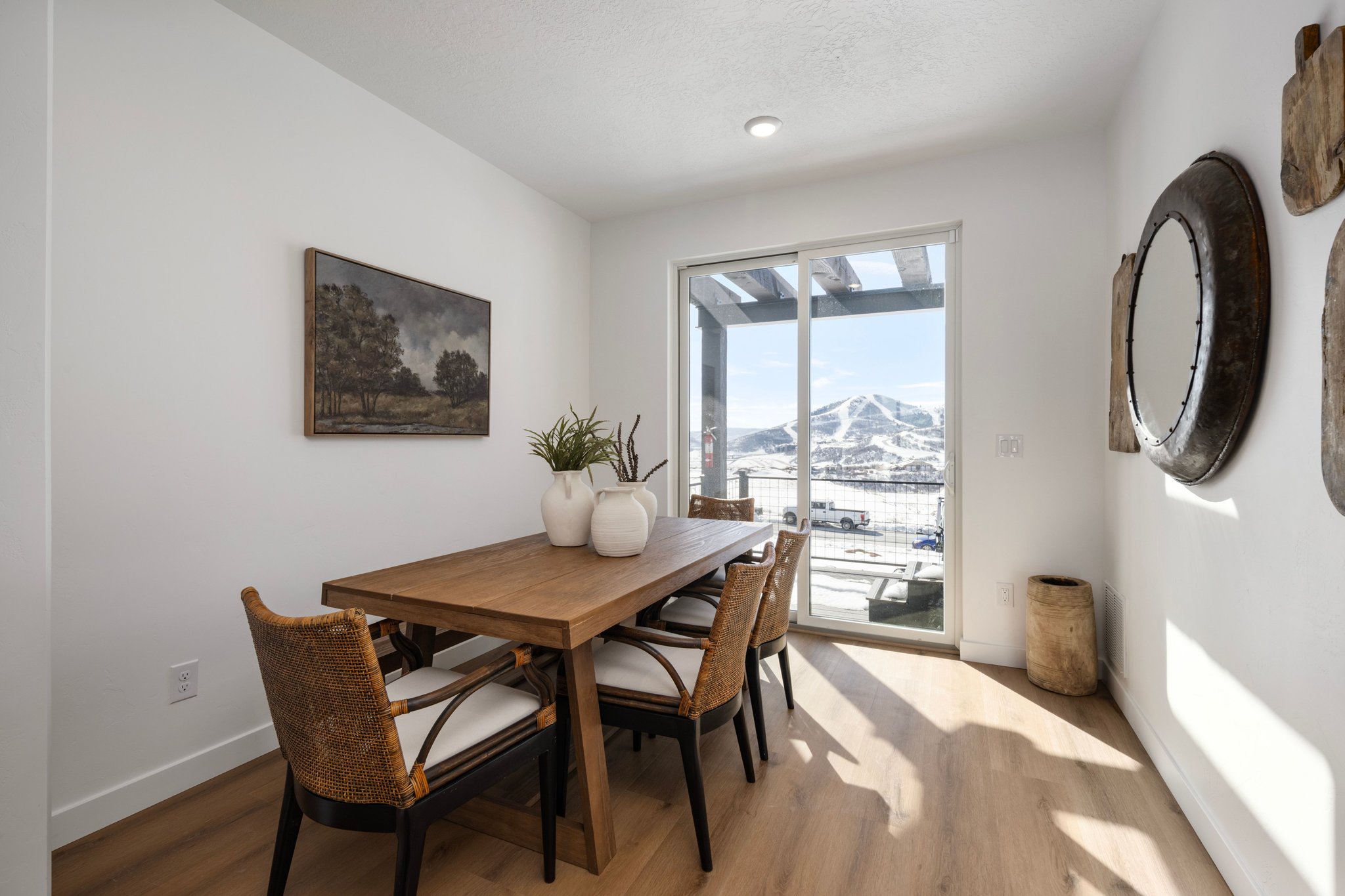 Dining area with light wood-style flooring and a mountain view