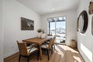 Dining area with light wood-style flooring and a mountain view