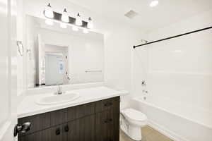 Bathroom with vanity,  shower combination, and light tile patterned floors