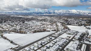 Snowy aerial view with a residential view and a mountain view