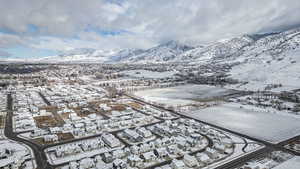 Snowy aerial view with a mountain view and a residential view