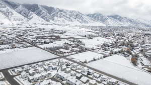 Snowy aerial view with a mountain view and a residential view