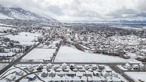 Snowy aerial view with a residential view and a mountain view
