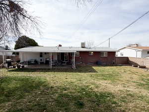 Rear view of property featuring a fenced backyard, a patio area, and brick siding