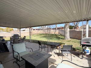 Fenced backyard with a patio, a grill, and outdoor lounge area