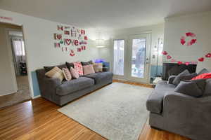 Living room with light wood-style flooring and a fireplace