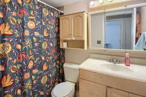 Full bathroom with a shower with shower curtain and vanity