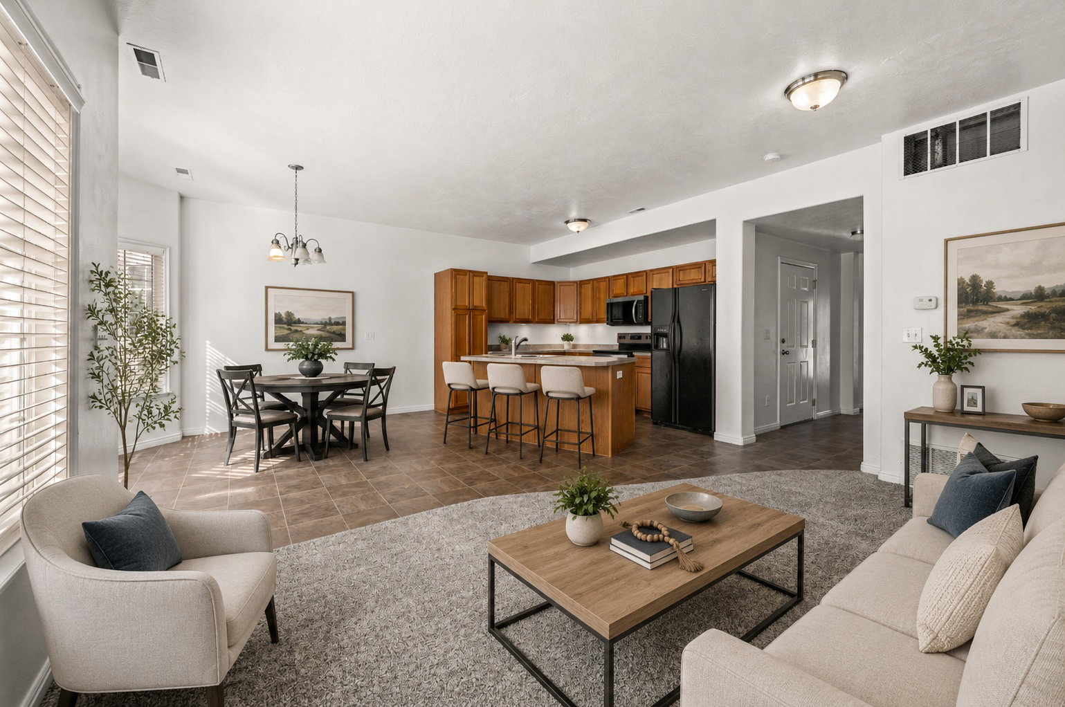 Open concept family room to kitchen and kitchen nook virtually staged.