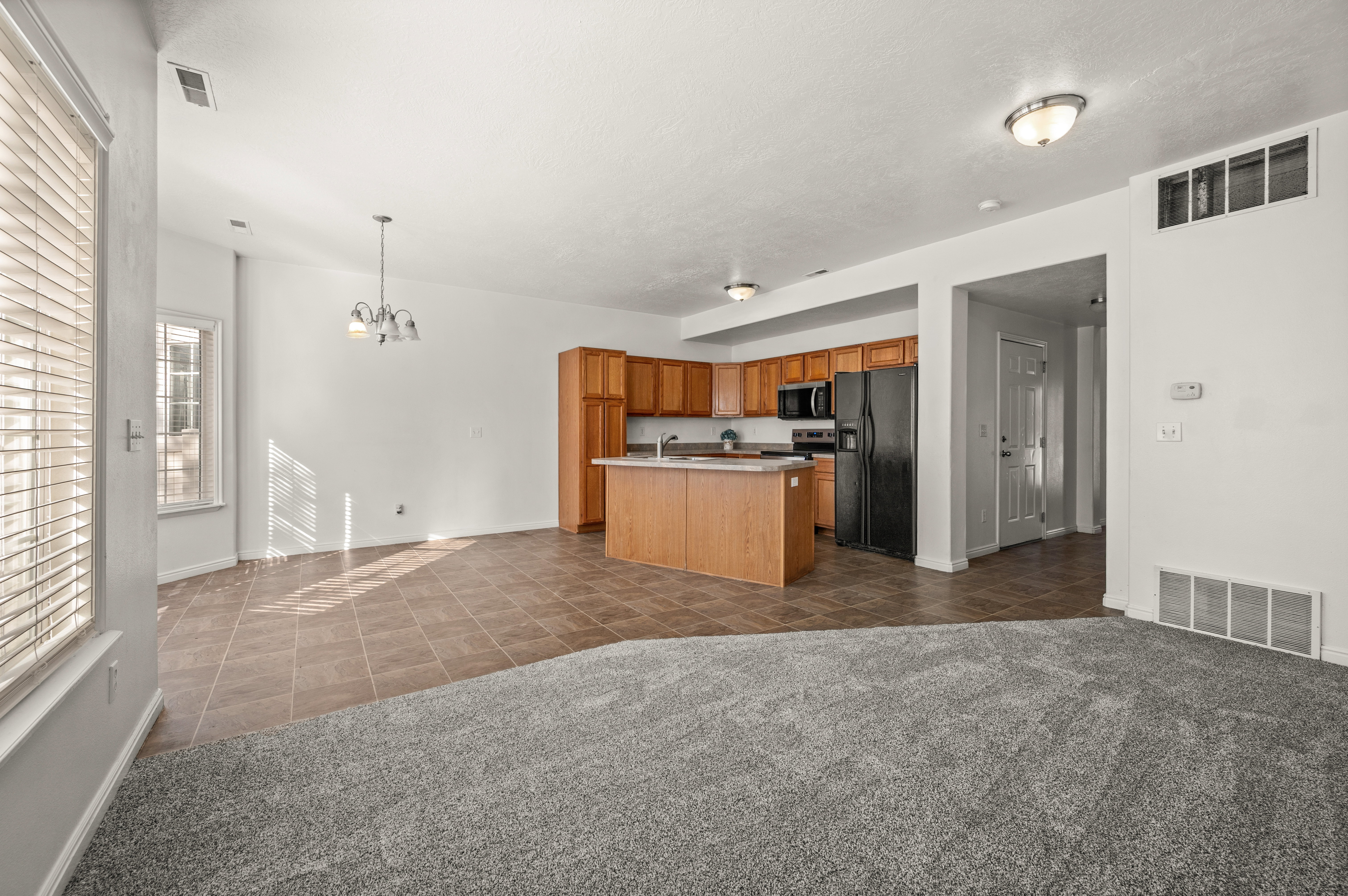 Open concept family room to kitchen and kitchen nook.
