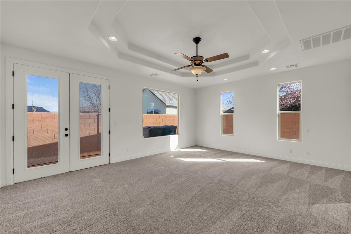 Spare room with ceiling fan, light carpet, french doors, and recessed lighting